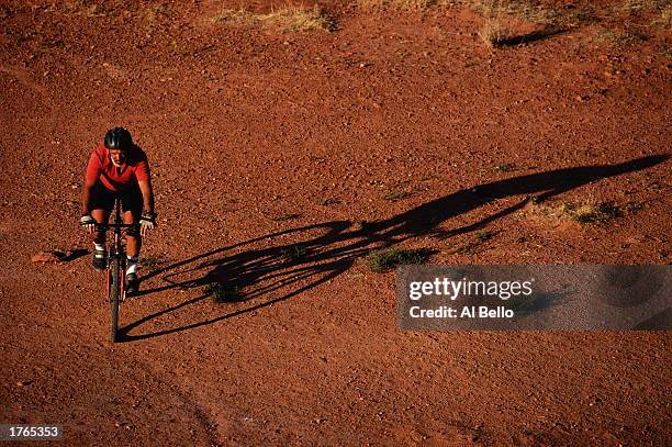 Mountain biking, mature man riding through arid landscape