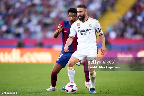 Dani Carvajal of Real Madrid CF controls the ball whilst under pressure from Alejandro Balde of FC Barcelona during the LaLiga EA Sports match...