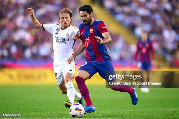 Ilkay Gundogan of FC Barcelona competes for the ball with Luka Modric of Real Madrid during the LaLiga EA Sports match between FC Barcelona and Real...