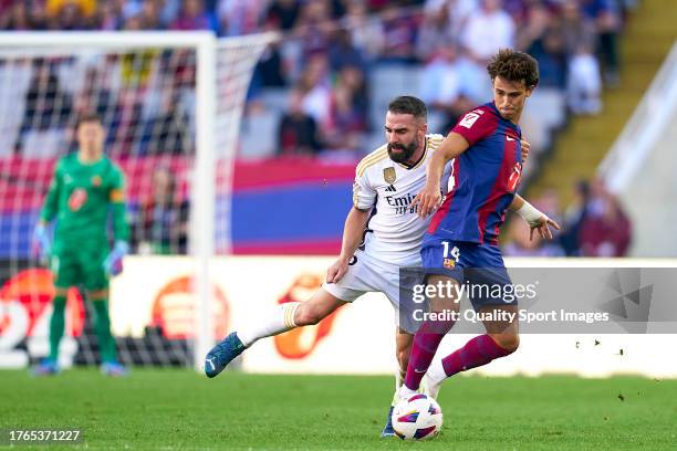 Joao Felix of FC Barcelona competes for the ball with Daniel Carvajal of Real Madrid during the LaLiga EA Sports match between FC Barcelona and Real...