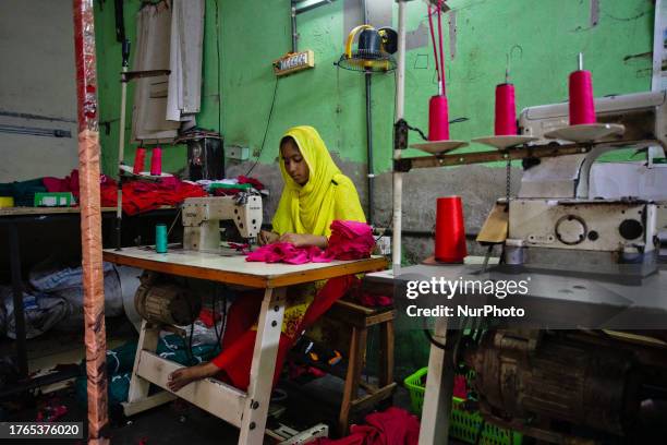 Teenage girl working with a sewing machine in a local ready made garment factory where they get paid really low compare to their adult co-workers...