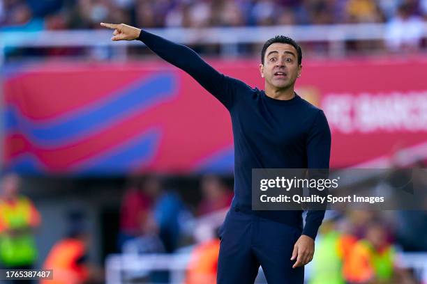 Xavi Hernandez, head coach of FC Barcelona gives instructions to their players during the LaLiga EA Sports match between FC Barcelona and Real Madrid...