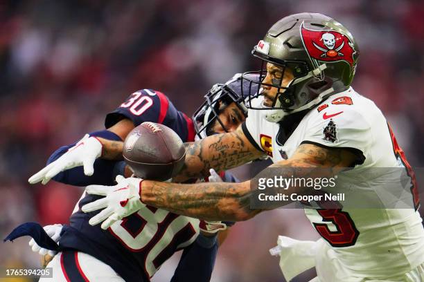 Mike Evans of the Tampa Bay Buccaneers recovers a fumble against DeAndre Houston-Carson of the Houston Texans during the second half at NRG Stadium...
