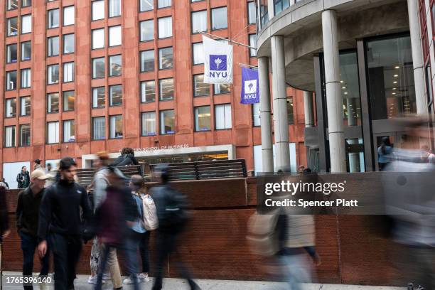 People walk by New York University as tensions between supporters of Palestine and Israel increase on college campuses across the nation on October...