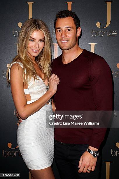 Australian model, Jennifer Hawkins poses with partner Jake Wall at the launch of her new self-tanning range 'J Bronze' at Bondi Beach on August 15,...