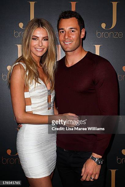 Australian model, Jennifer Hawkins poses with partner Jake Wall at the launch of her new self-tanning range 'J Bronze' at Bondi Beach on August 15,...