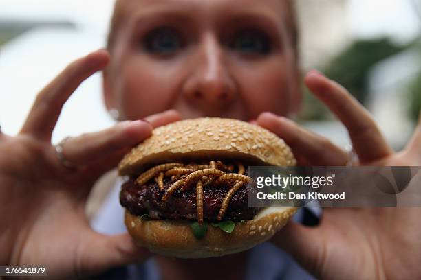 Woman from Rentokil poses with a Pigeon and Mealworm burger on a 'Pop Up' stand at One New Change on August 15, 2013 in London, England. The pest...