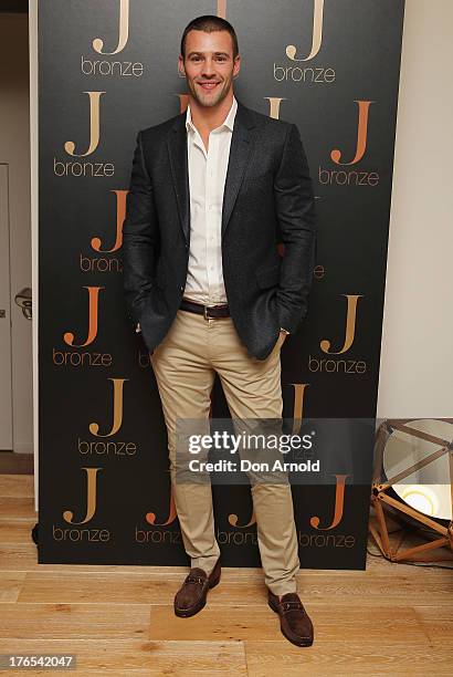 Kris Smith poses at the launch of Jennifer Hawkins new self-tanning range at Bondi Beach on August 15, 2013 in Sydney, Australia.