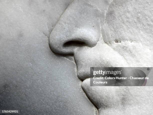 close-up of the nose and mouth of a sculpture in paris, france - body men close up stock-fotos und bilder