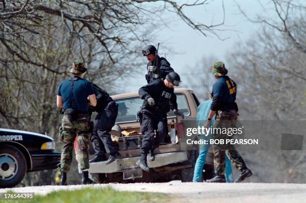 Agents unload from a pickup truck on March 12, 1993 near the Branch Davidian religious compound. After a shootout in Waco in 1993 that killed four...