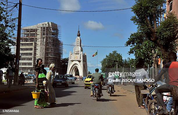 People drive in central Bamako on August 15, 2013 as Mali announced today Ibrahim Boubacar Keita as its new leader after confirming that the ex-prime...