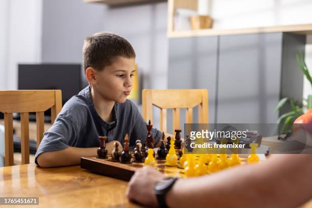 boy playing chess - chess timer stock pictures, royalty-free photos & images