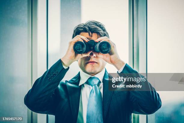 businessman spying with binoculars - viewing binoculars stock pictures, royalty-free photos & images