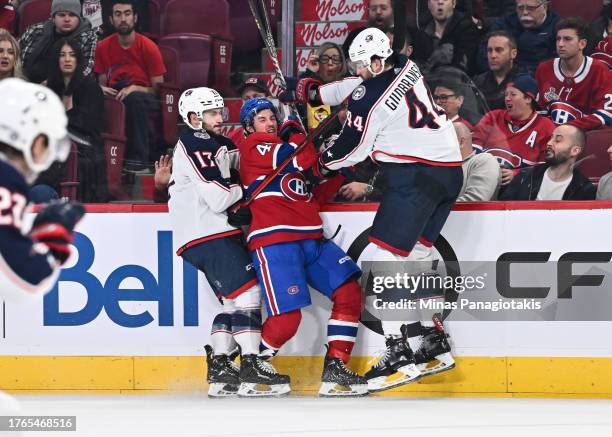 Rafael Harvey-Pinard of the Montreal Canadiens is caught along the boards between Justin Danforth and Erik Gudbranson of the Columbus Blue Jackets...