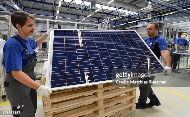 Workers stack finished solar energy panels at the Solarworld plant on August 14, 2013 in Freiberg, Germany. The troubled solar cells, modules and...