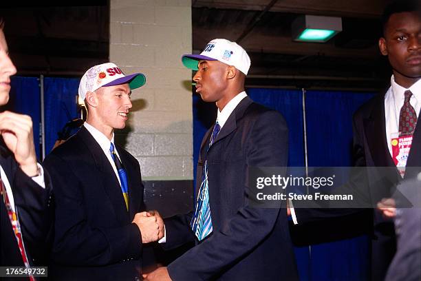 Kobe Bryant who was drafted number thirteen overall by the Charlotte Hornets and Steve Nash, drafted number fifteen overall by the Phoenix Suns greet...