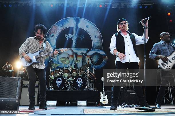 Steve Lukather, Simon Phillips, Joseph Williams, and Nathan East of Toto perform at Chastain Park Amphitheater on August 14, 2013 in Atlanta, Georgia.