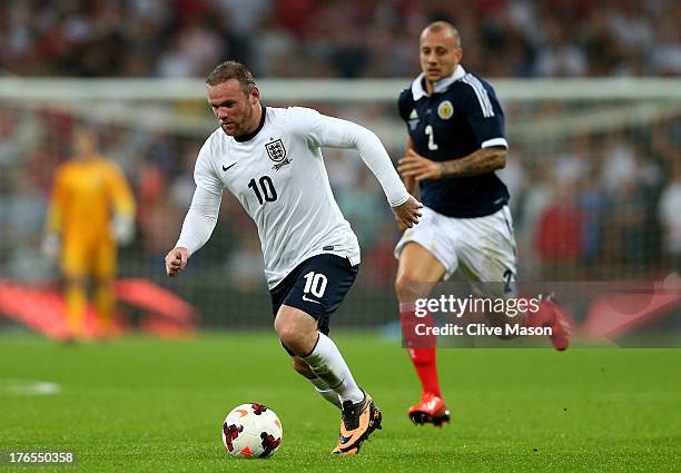 Wayne Rooney of England is pursued by by Alan Hutton of Scotland during the International Friendly match between England and Scotland at Wembley...