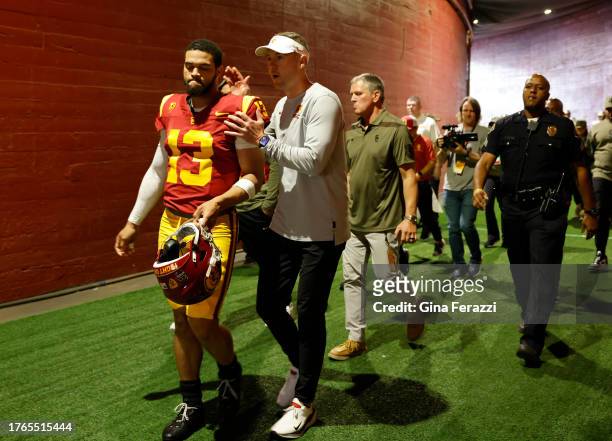 Trojans head coach Lincoln Riley walks out of the tunnel with USC Trojans quarterback Caleb Williams before the game against Washington at the L.A....
