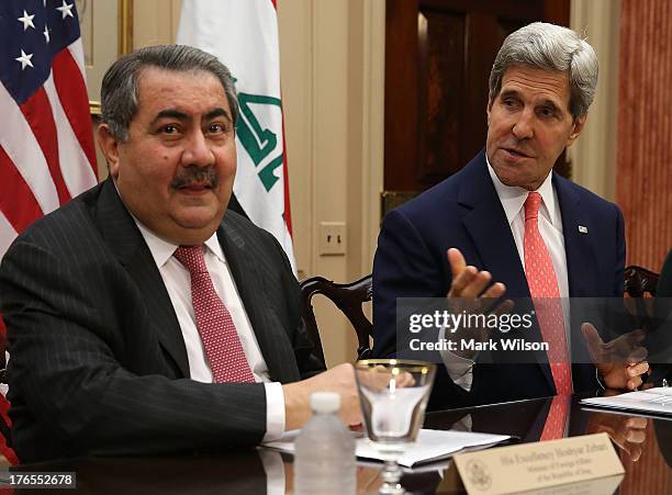 Secretary of State John Kerry speaks while flanked by Iraqi Foreign Minister Hoshyar Zebari during a meeting at the State Department August 15, 2013...