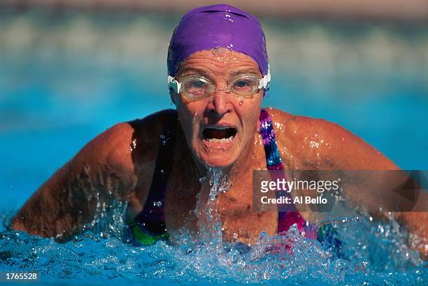 Female swimmer coming up for air during race, close-up