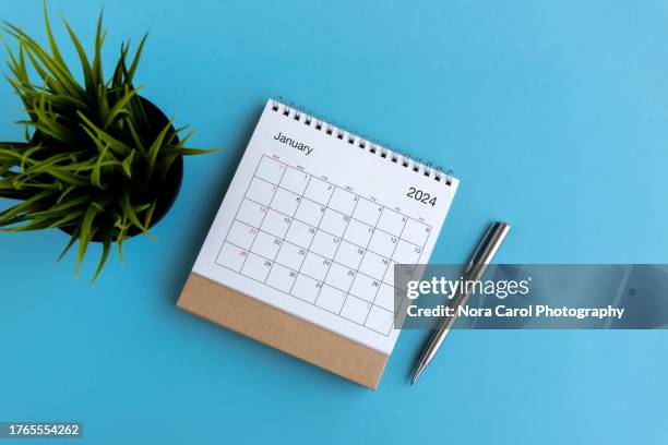 january 2024 desk calendar on blue background - january 2021 stock pictures, royalty-free photos & images