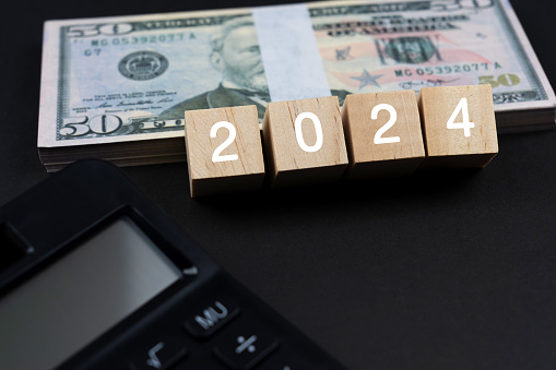 New year 2024 concept with paper money and calculator
