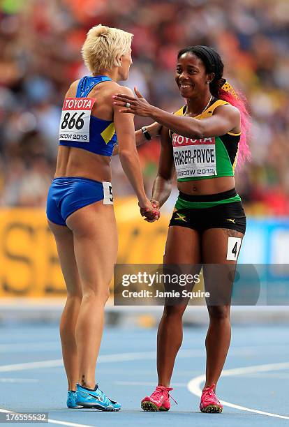 Shelly-Ann Fraser-Pryce of Jamaica and Mariya Ryemyen of Ukraine after the Women's 200 metres semi finals during Day Six of the 14th IAAF World...