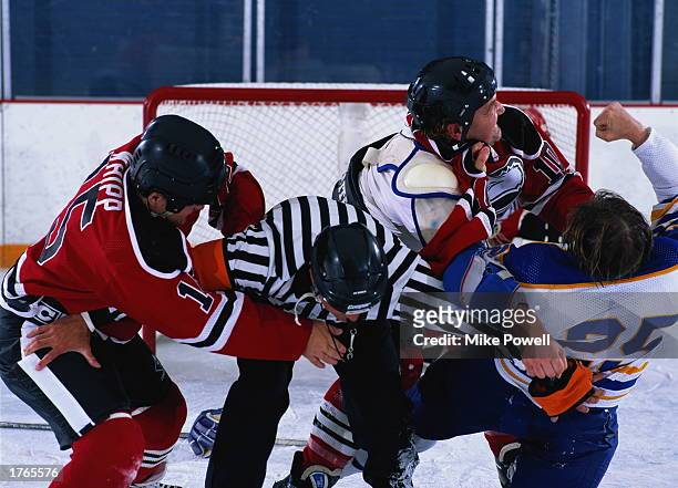 Ice hockey, referee attempting to break up fight, close-up