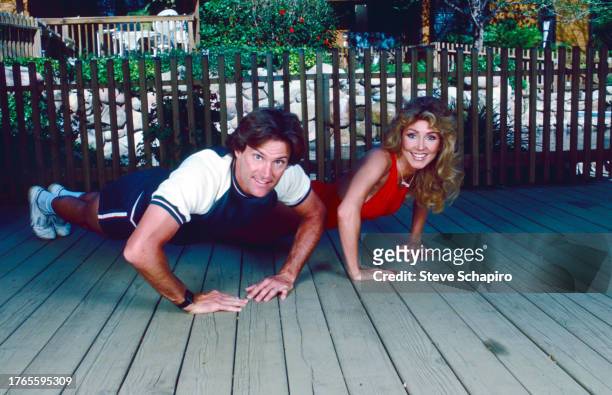 Married American couple, Olympic athlete Bruce Jenner and model & actress Linda Thompson Jenner do push-ups as they exercise together, Los Angeles,...