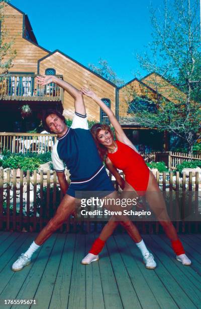 Married American couple, Olympic athlete Bruce Jenner and model & actress Linda Thompson Jenner stretch as they exercise together, Los Angeles,...