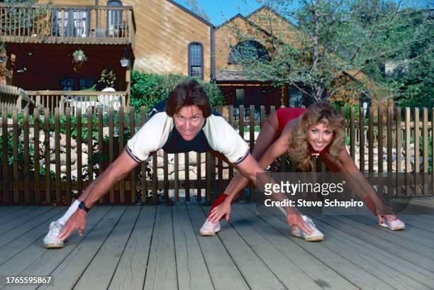 Married American couple, Olympic athlete Bruce Jenner and model & actress Linda Thompson Jenner stretch as they exercise together, Los Angeles,...