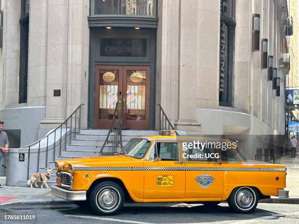 Vintage checker cab parked in front of Cocoa Exchange residential building, 1 Wall Street New York City, New York.
