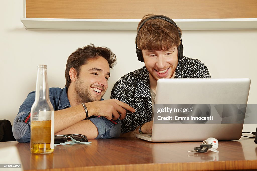 Friends indoor looking at computer screen