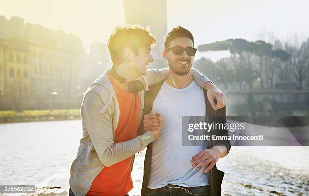 friends, celebrating, sunset, river bank - modern manhood stock pictures, royalty-free photos & images