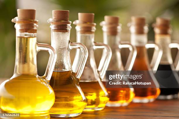 olive oil and vinegar in bottles on the table - vinegar stockfoto's en -beelden