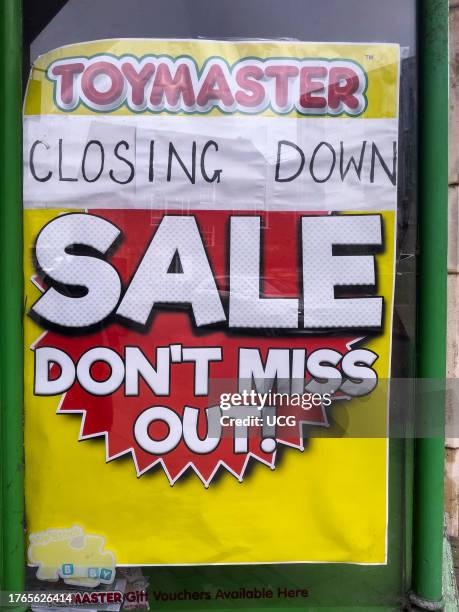 Closing down sale sign on a toy shop window in the city center of Winchester, UK.