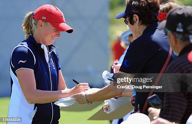 Stacy Lewis of the United State Team signs autographs during a practice round prior to facing the European Team in the 2013 Solheim Cup on August 15,...