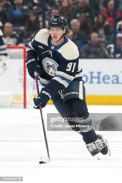 Kent Johnson of the Columbus Blue Jackets skates with the puck during the second period against the New York Islanders at Nationwide Arena on October...