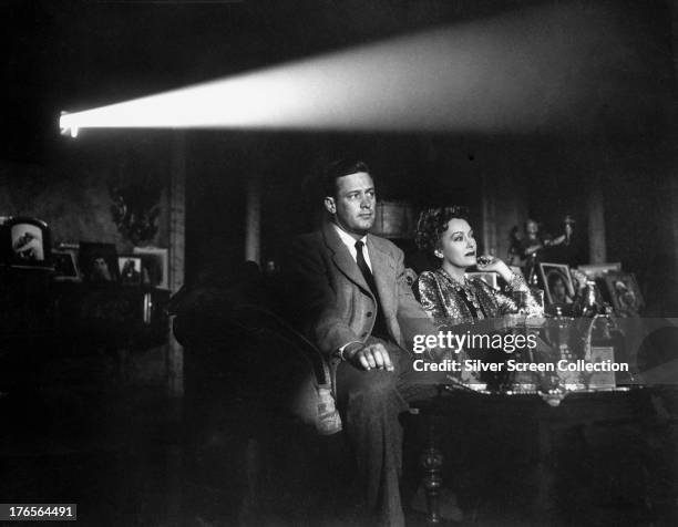 Joe Gillis, played by William Holden and Norma Desmond, played by Gloria Swanson , watch the screening of a film in 'Sunset Boulevard', directed by...