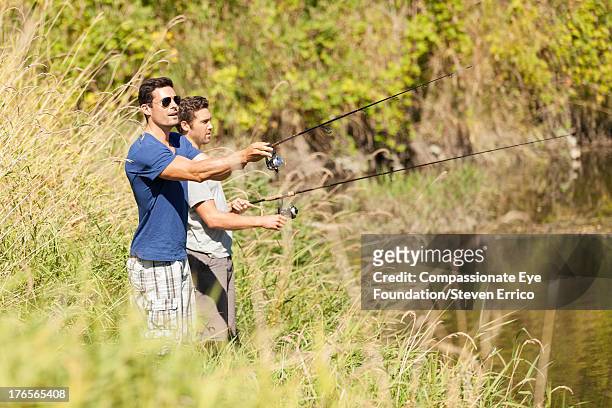 men standing by river fishing - langley british columbia stockfoto's en -beelden