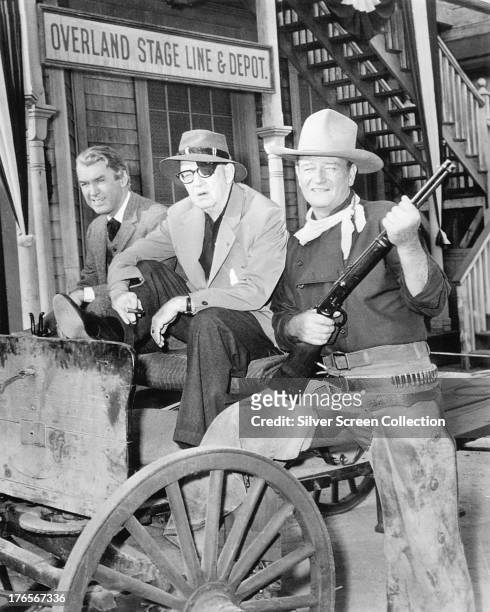 American actors James Stewart and John Wayne with director John Ford on the set of 'The Man Who Shot Liberty Valance', 1962.