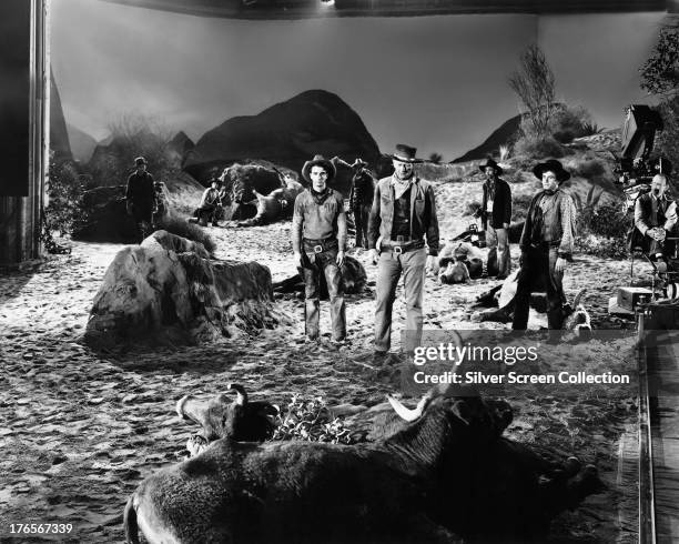 American actors Montgomery Clift as Matthew 'Matt' Garth, John Wayne , as Thomas Dunson and Noah Beery Jr. As Buster McGee on the set of 'Red River',...