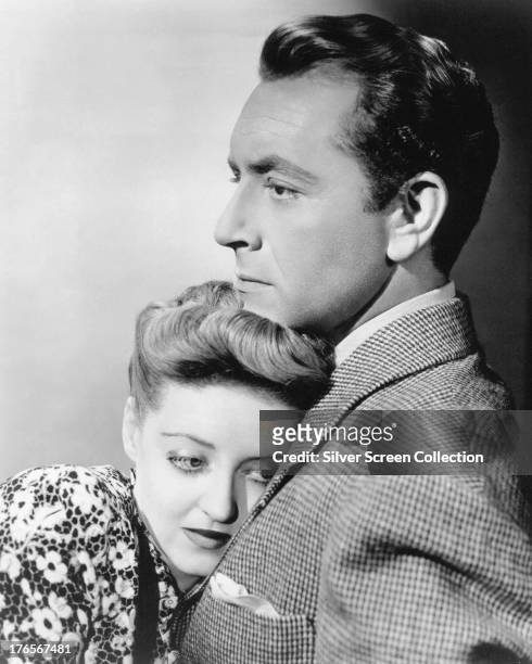 American actress Bette Davis as Charlotte Vale, and Paul Henreid as Jerry Durrance in 'Now, Voyager', directed by Irving Rapper, 1942.