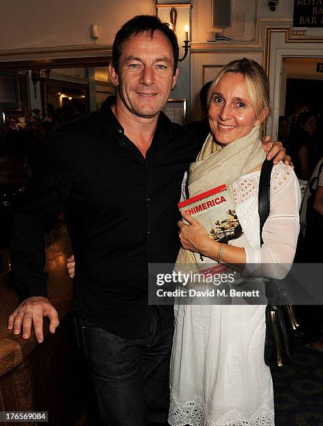 Jason Isaacs and Emma Hewitt pose in the foyer following the press night performance of 'Chimerica' at the Harold Pinter Theatre on August 15, 2013...