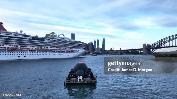 Giant spider sits on a barge floating on Sydney Harbour as Carnival Splendor arrives on October 31, 2023 in Sydney, Australia. Carnival Cruise Line's...