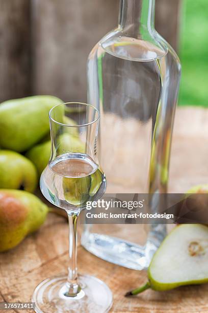 bottle pear fruit brandy  birnenschnaps - grappa stock pictures, royalty-free photos & images