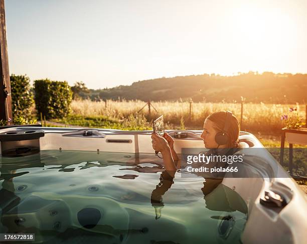 woman in whirlpool hot tub with digital tablet - tablet outside stock pictures, royalty-free photos & images