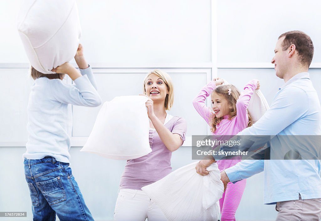 Young family having a pillow fight!