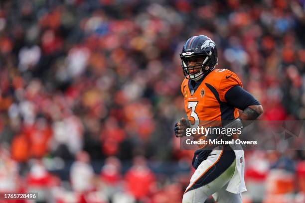 Russell Wilson of the Denver Broncos runs during an NFL football game between the Denver Broncos and the Kansas City Chiefs at Empower Field At Mile...